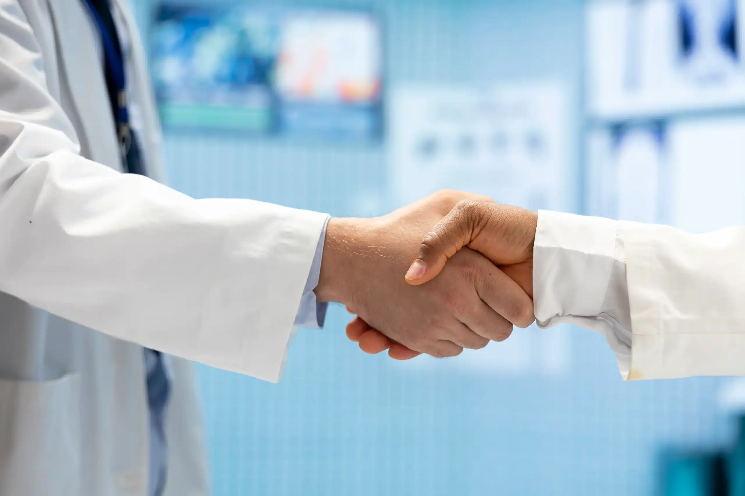 medical staff doing handshake end cabinet meeting scaled